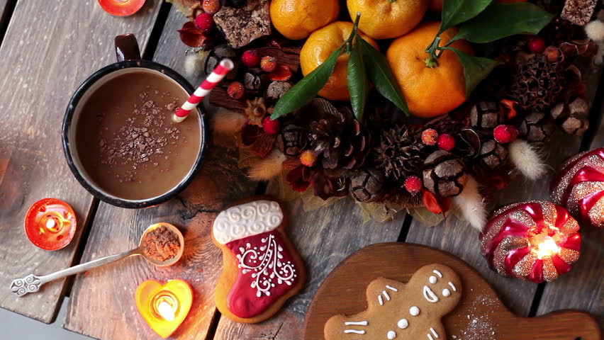 Christmas homemade gingerbread cookies, hot chocolate and candles on wooden table