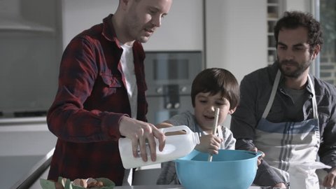 Same sex couple family cooking biscuits