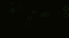 Motion green round. High quality royalty free stock footage and visuals featuring green bokeh orb shaped particle motion on black  backgrounds. 