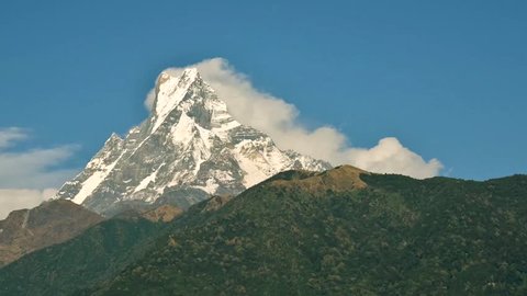 Clouds rolling down the Machapuchare in Nepal, time-lapse cinemagraph seamless loop