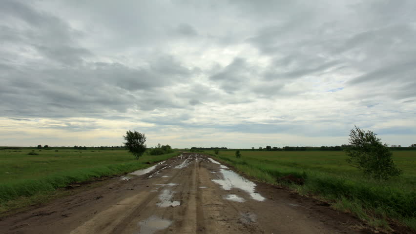 Movement of clouds over a dirt road. Lubinsky District, Omsk Region, Russia, Full HD

