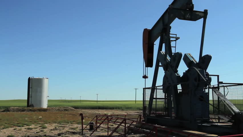 Crude oil pump jack with storage tank