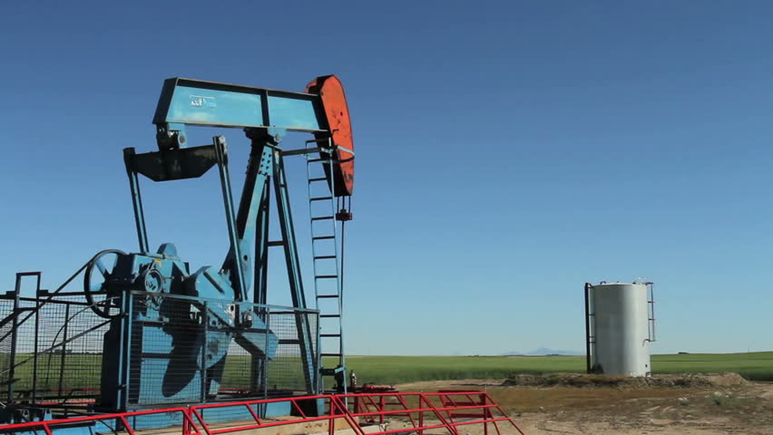 Crude oil pump jack with storage tank