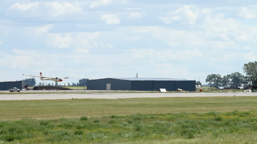 Sailplane landing on airstrip