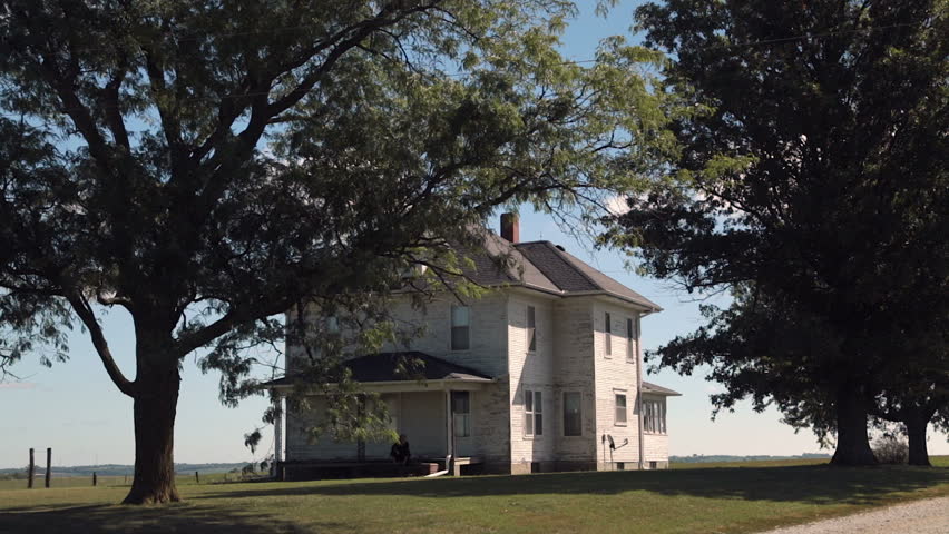 Historic farmhouse with trees. Iowa, USA