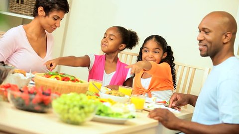 Young african american family sharing a healthy lunch together at home 