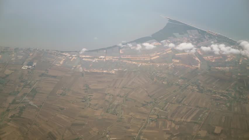 View from the top, above the clouds, rural and seaside scene below, space for text