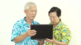Video Asian Senior couple video call to family from holiday trip. Happily smiling at computer cam