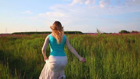 Young woman running in field. Stock Video