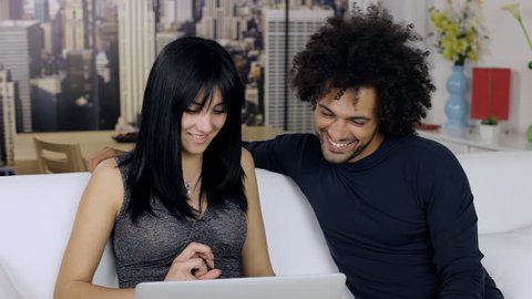 Cute couple playing with pc having fun shopping online