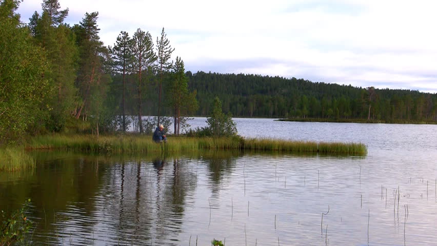 fishermen fishing on lake, norway