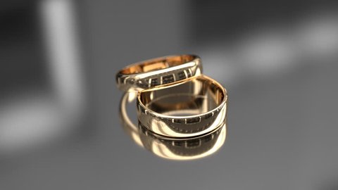 Wedding rings on glossy background Stockvideó