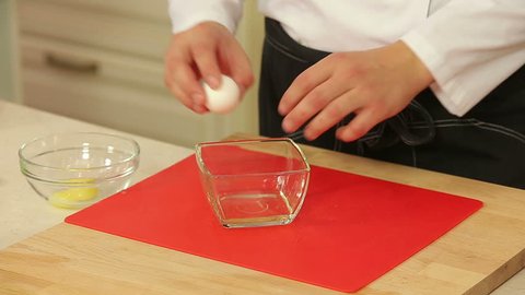 Chef is separating egg yolk from white