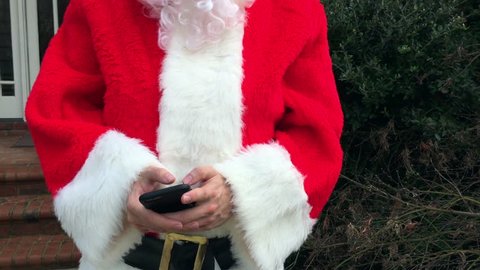 Santa Claus texting and shopping on his cell phone
