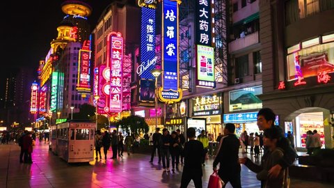 Shanghai - November 2015: Hyperlapse of Nanjing Road with people and colorful signboards glowing at night. 4K resolution
