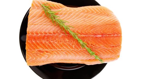 raw fresh uncooked salmon red fish fillet on black plate with rosemary twig 1920x1080 intro motion slow hidef hd