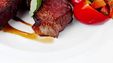 meat food : big grill beef steak on white plate with red hot chili pepper and raw cherry tomato 1920x1080 intro motion slow hidef hd