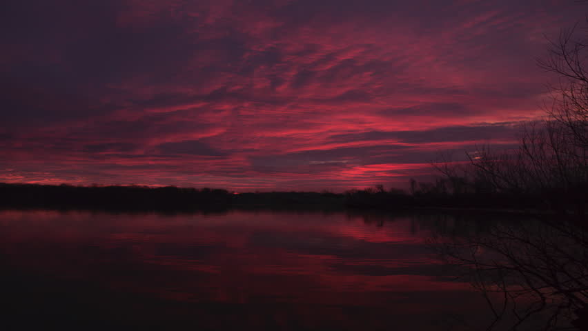 Red sky at morning, dawn over Fox River, De Pere, Wisconsin, time lapse.
