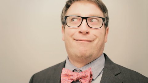 Funny business man making silly confused faces closeup 