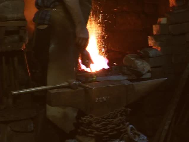 Blacksmith forming metal.