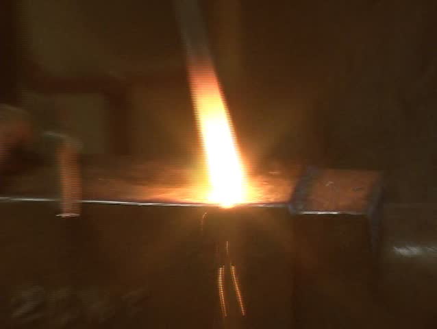 Blacksmith working on metal.