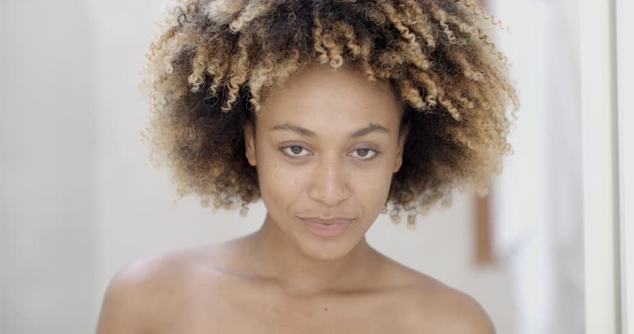 Portrait of young woman causes powder to face