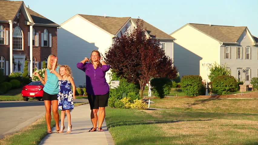 A small group of women dance outside.