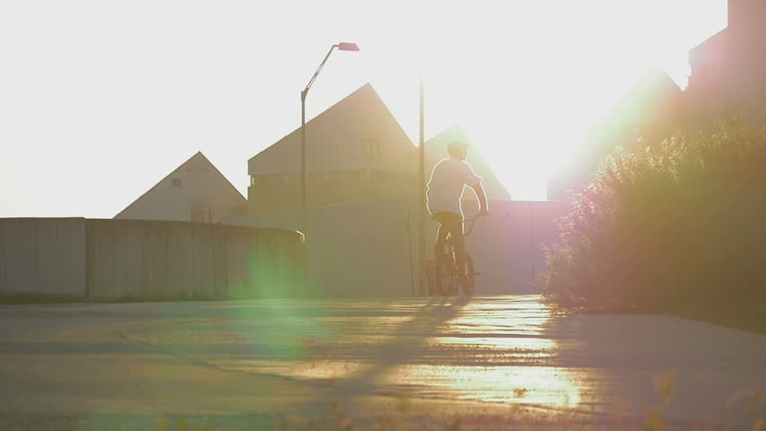 A bmx rider riding to the sunset