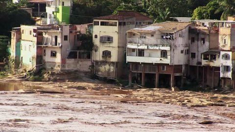 Brown, toxic water from a broken mine dam flows down the river Rio Doce on November 11, 2015 in Governador Valadares.