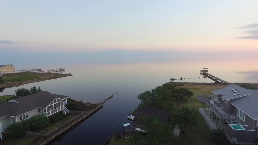 Sunrise drone shot at Ocracoke Island, NC showing the calm reflection off the waters of the Pamlico Sound.