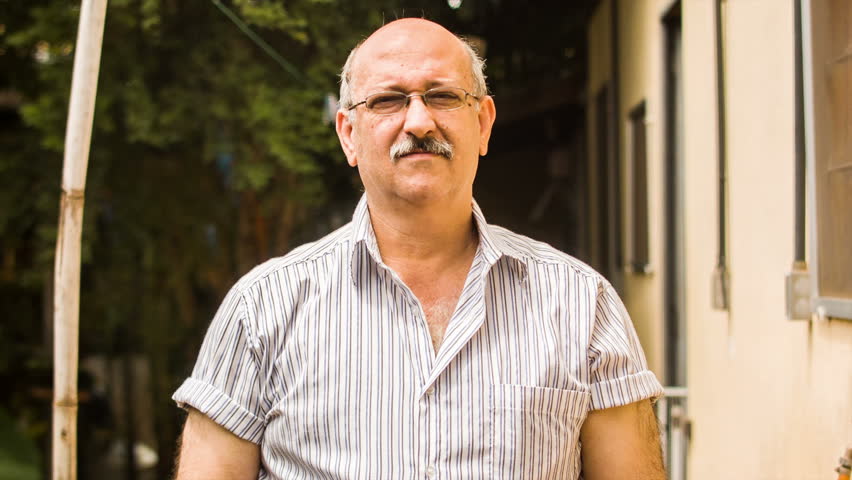 A Brazilian gentleman standing look at the camera