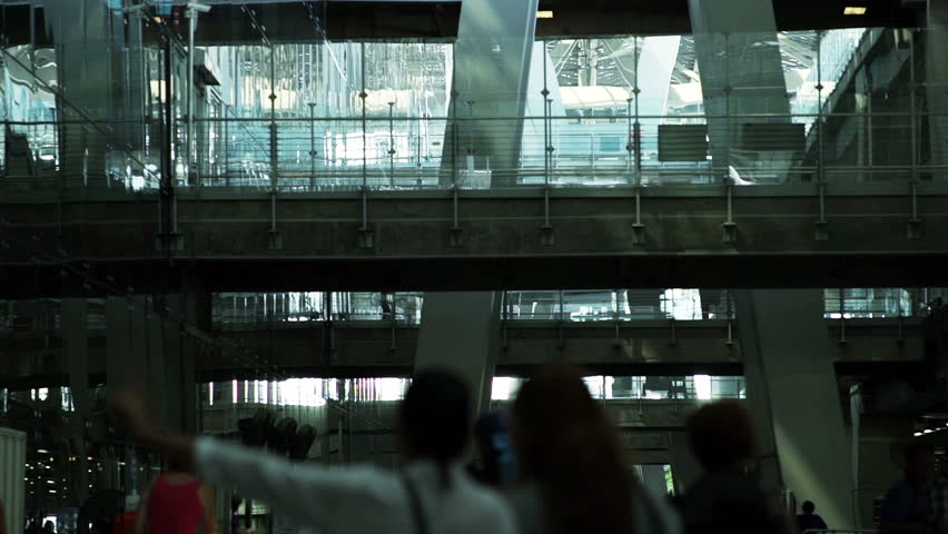 Crowd of travelers arriving for check-in at a busy airport