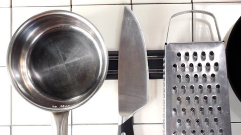 kitchen implements hanging on a magnetic holder