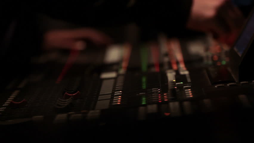 Rack focus across a complex sound mixing board.