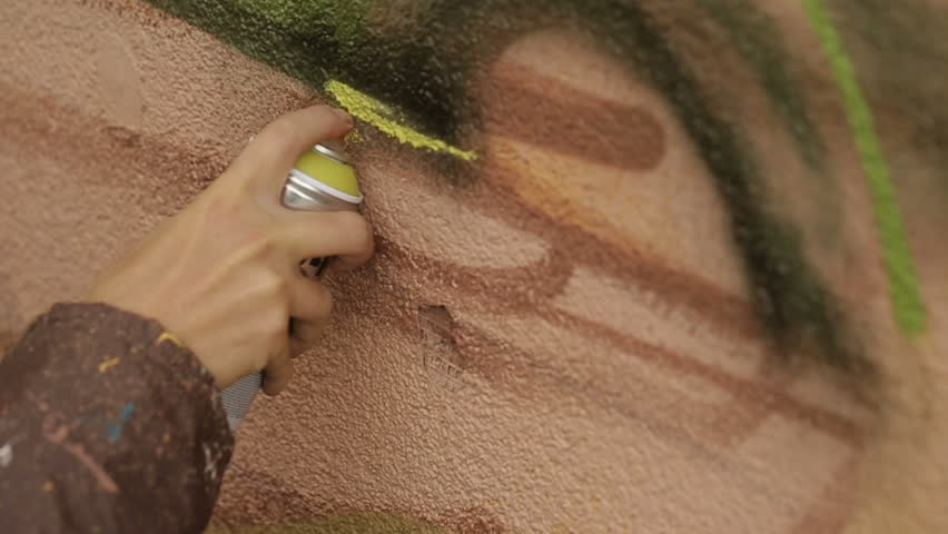 Man hand  Painting Graffiti On The Wall