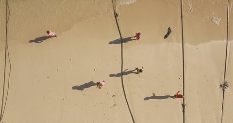 Krabi, Thailand, November 2015: Birds eye view aerial shot of kids playing on a beach in Thailand Editorial Stock Video