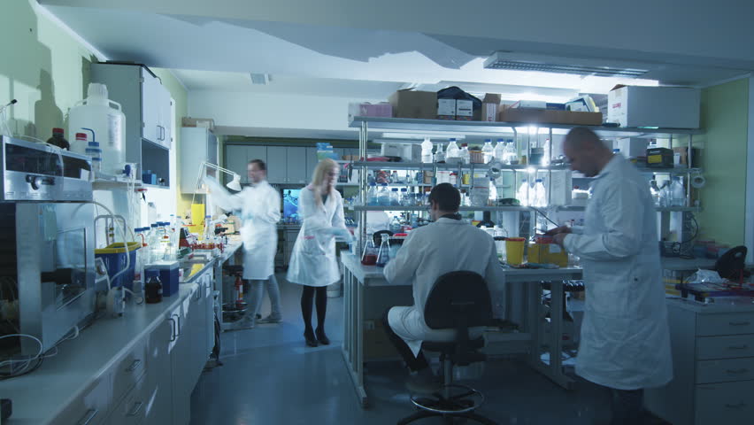 Timelapse footage of a team of scientists in white coats that are working in a modern laboratory. Shot on RED Cinema Camera in 4K (UHD).