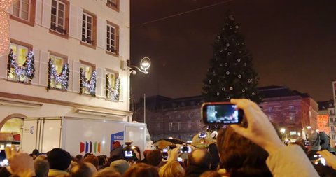 STRASBOURG, FRANCE - CIRCA 2015: People counting down for Christmas Tree light and photographing the beautiful illuminations of the Christmas Tree in the French city of Strasbourg, France, Alsace
