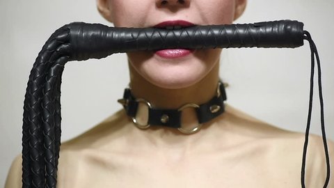 slave attractive woman with whip in mouth