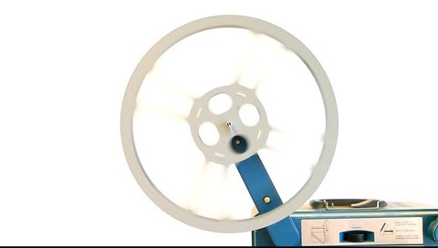 Old movie projector reel on a white background