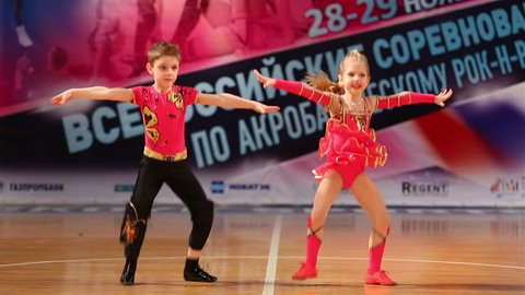 MOSCOW, RUSSIA - NOVEMBER 29, 2015: Little dancers. Children pair incendiary dance sports acrobatic rock-n-roll. National competition in acrobatic rock-n-roll at the Palace of sports "Dynamo".
