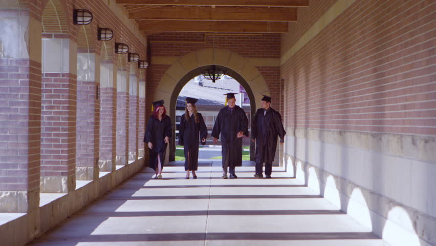 Graduating students walking through the hallway into blur