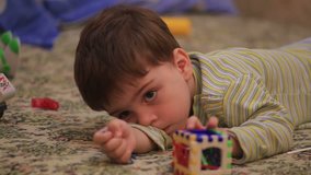 Little boy playing with toys depicting different emotions