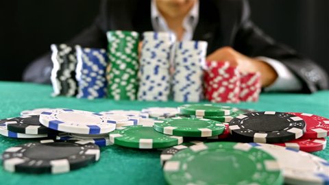A gambler at a poker table doing fold