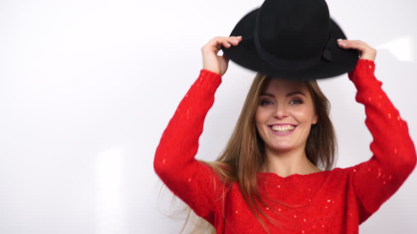 Take your hat. Put on a hat. Put on your hat. Putting hat girl. Woman putting on a hat.