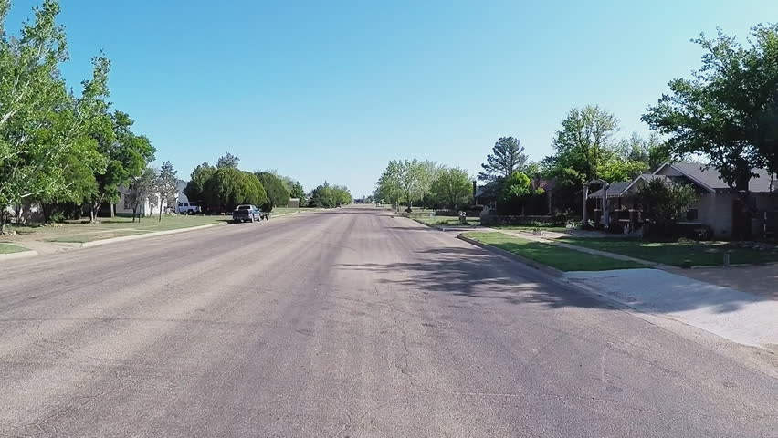 MATADOR, TX/USA - August 3, 2015: Driving past homes in a small North Central Texas town. A vehicle