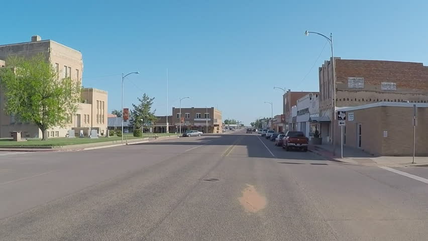 Point of view driving shot of going past the county court house in Paducah Texas. A driver