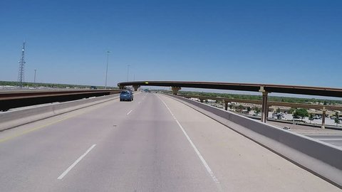 LUBBOCK, TX/USA - July 11, 2015: Point of view vehicle driving shot of driving on a new freeway ramp. A traveler's viewpoint of passing over and through an overpass and freeway interchange.