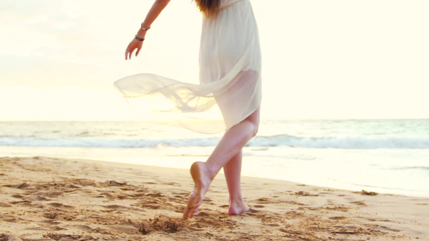 Gorgeous Girl Having Fun at the Beach on Luxury Island at Sunset. Model Girl Spinning in SLOW MOTION Splashing Feet Wet. Royalty-Free Stock Footage #13121846