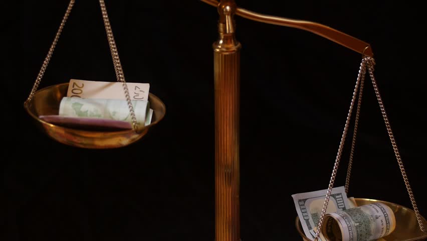 Euro and US dollars on scale fast motion black background